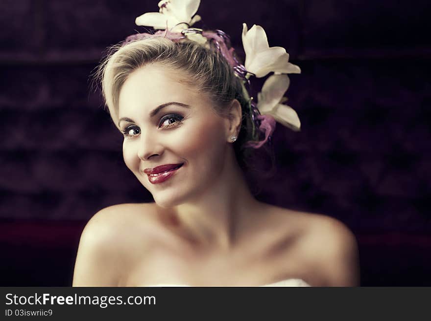 Portrait of young beautiful blond woman with stylish hair-do