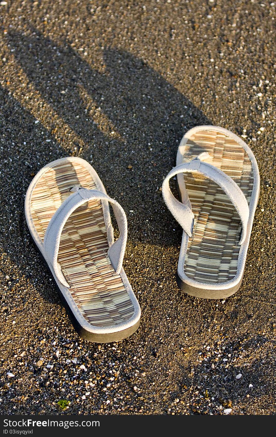 Flip flop on sandy beach in front of the sea. Flip flop on sandy beach in front of the sea