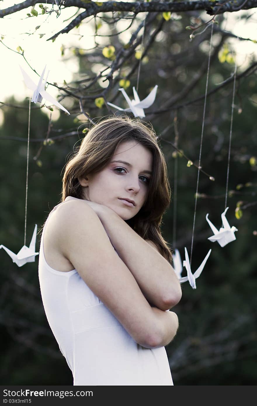 A portrait of a young woman standing in the park