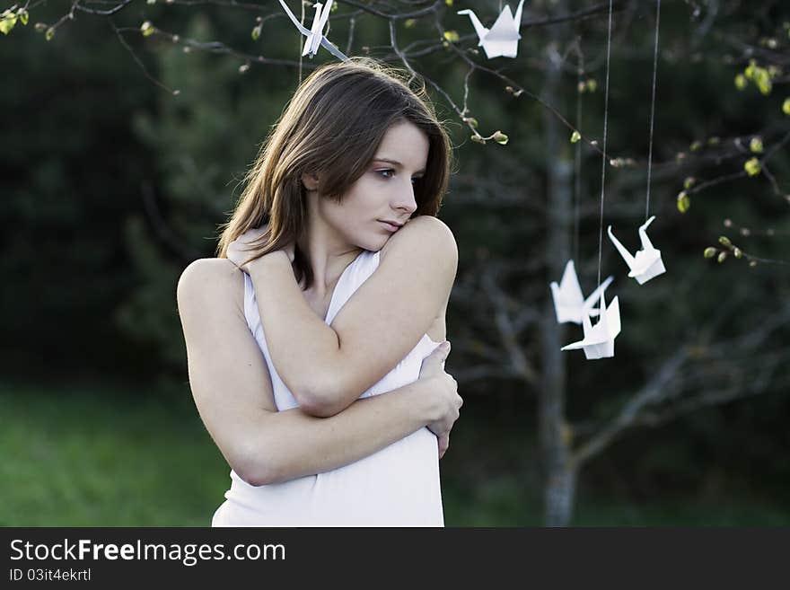 A portrait of a young woman standing in the park