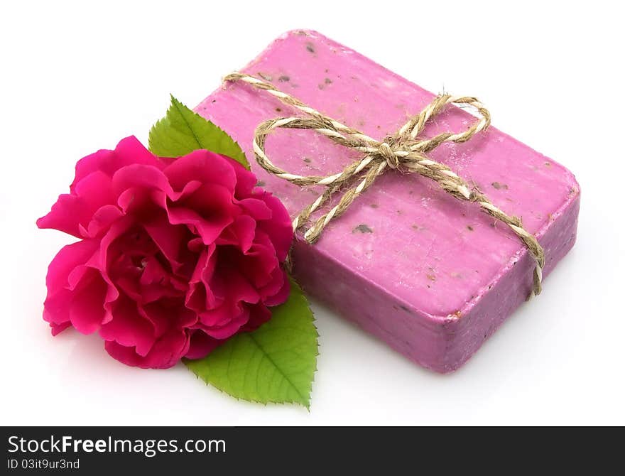 Pink soap with rose on white