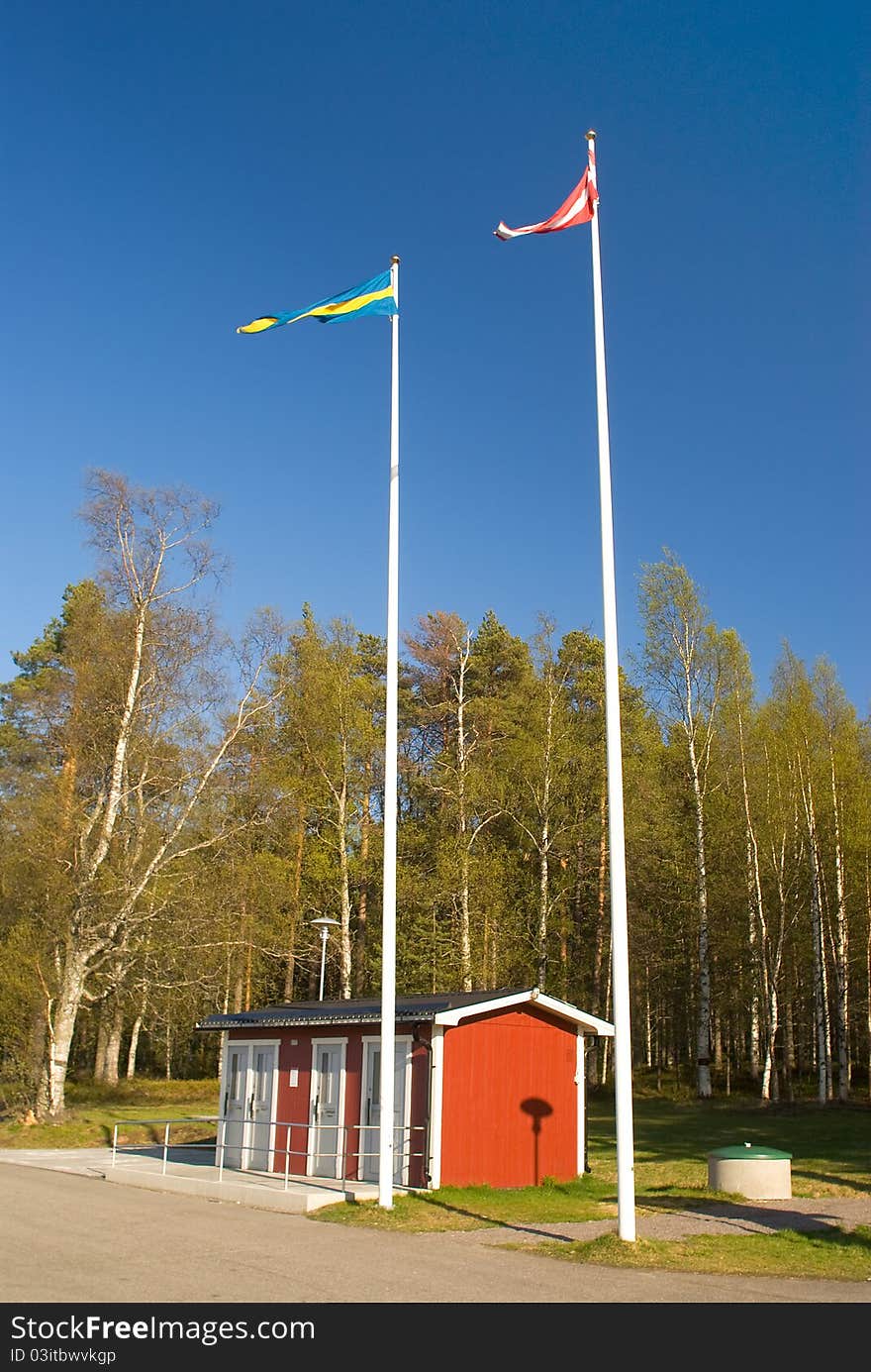 Flag of Sweden and Denmark on the background of the park