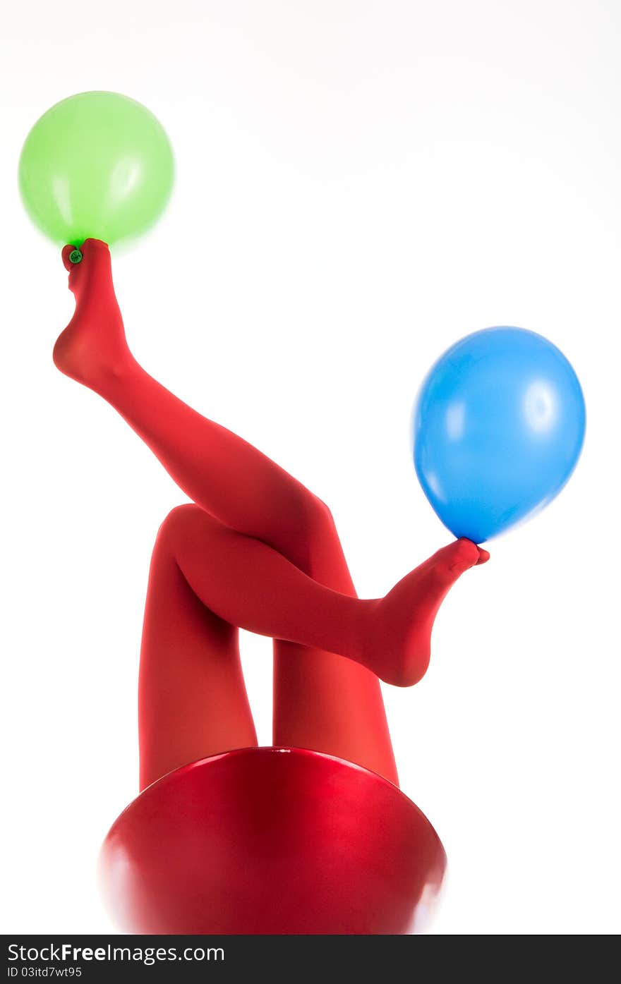 Female feet in red stockings with balloons isolated in white