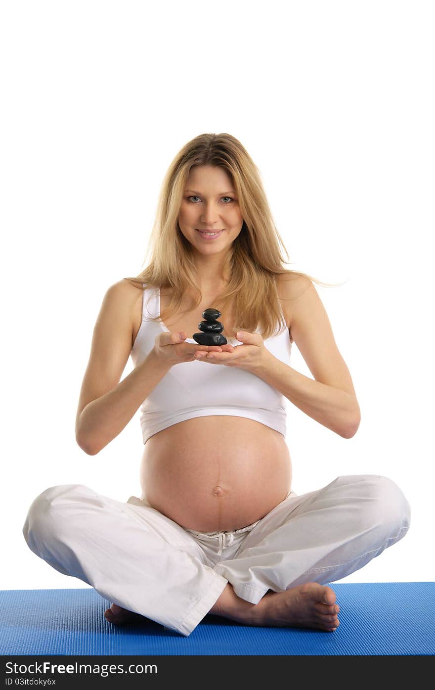 Pregnant woman holding pile of stones isolated on white