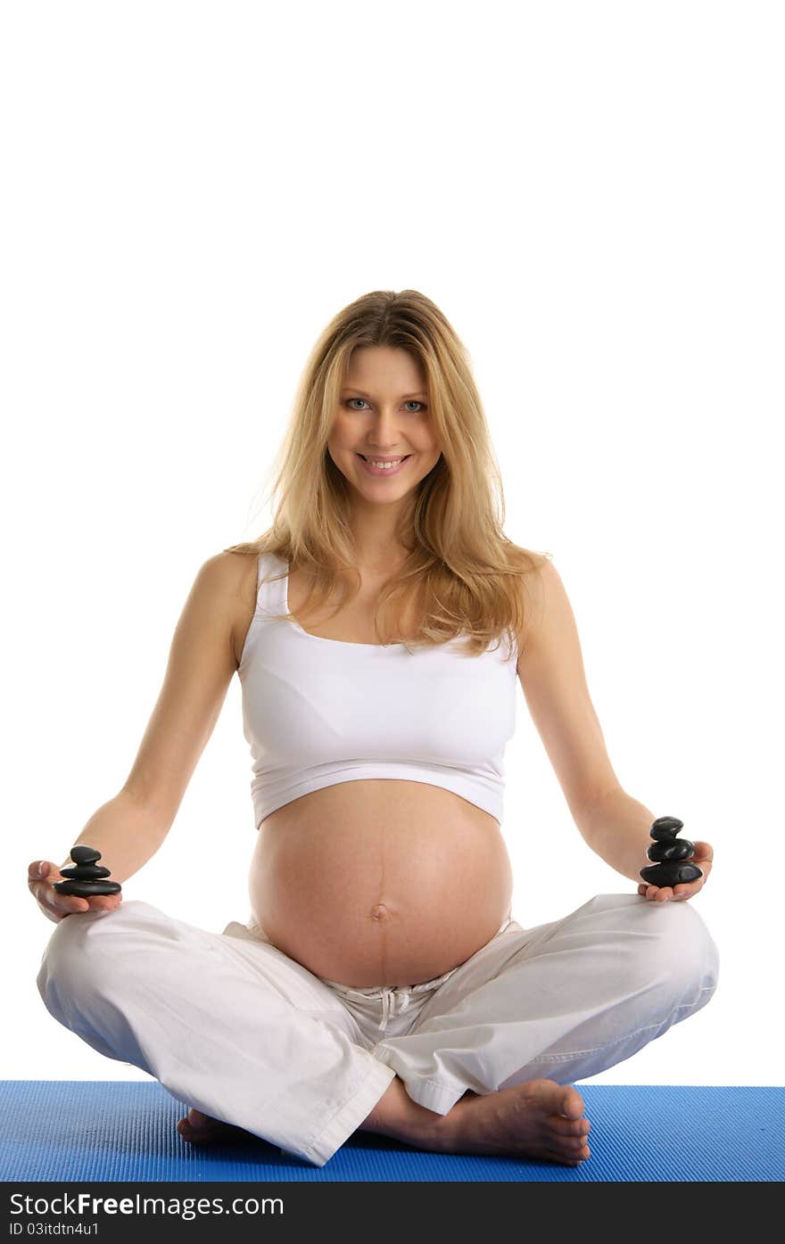 Pregnant woman with hill of stones isolated on white