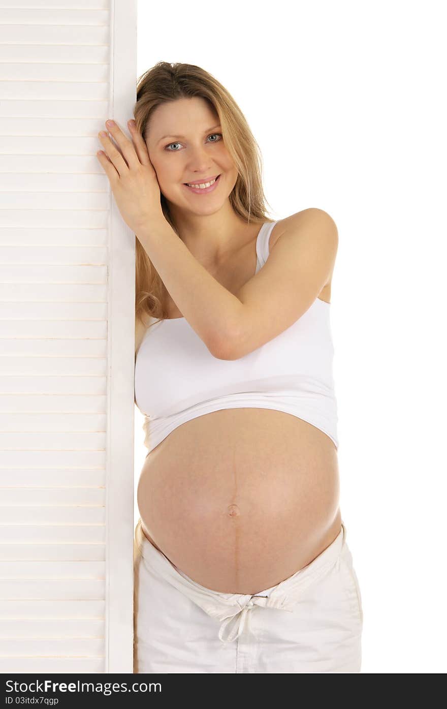 Happy Pregnant Woman Standing Near The Door