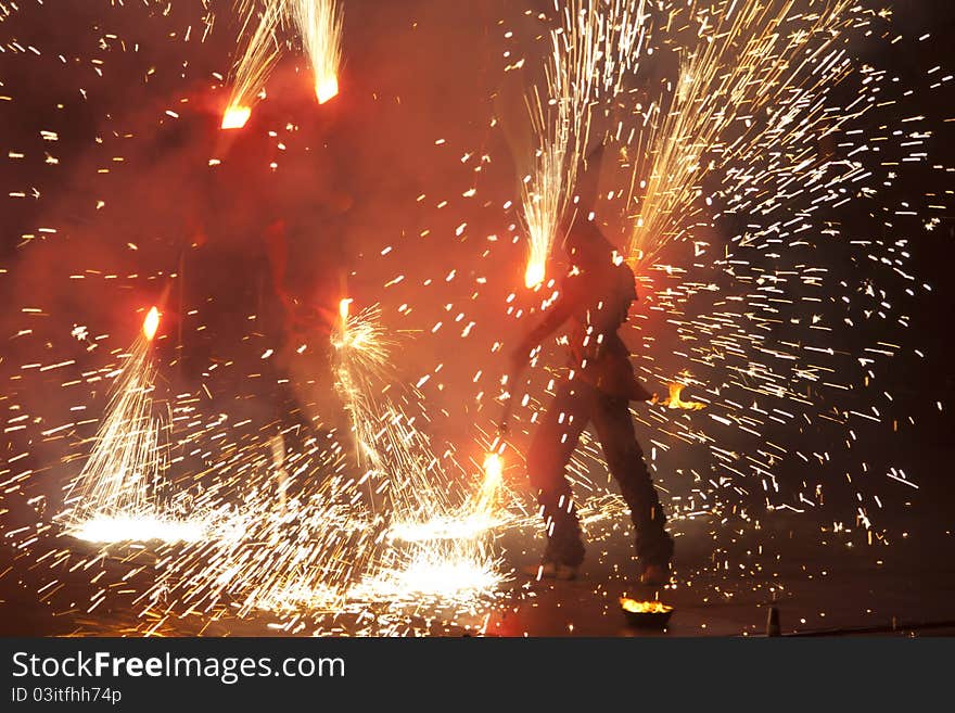 Kiev, Ukraine - June the 11-th, 2011: Kiev Fire Fest at 'Spartak' stadium. An artist juggles with sparkling staffs. Kiev, Ukraine - June the 11-th, 2011: Kiev Fire Fest at 'Spartak' stadium. An artist juggles with sparkling staffs