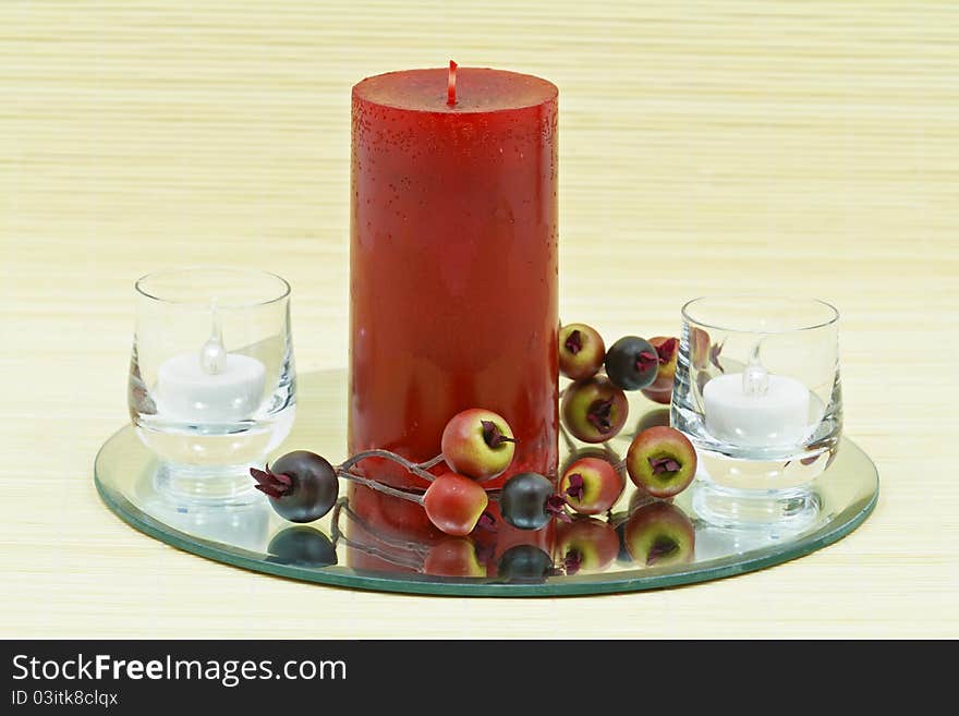 Beautiful home decoration with candle and decorative flower on small brown bamboo rug