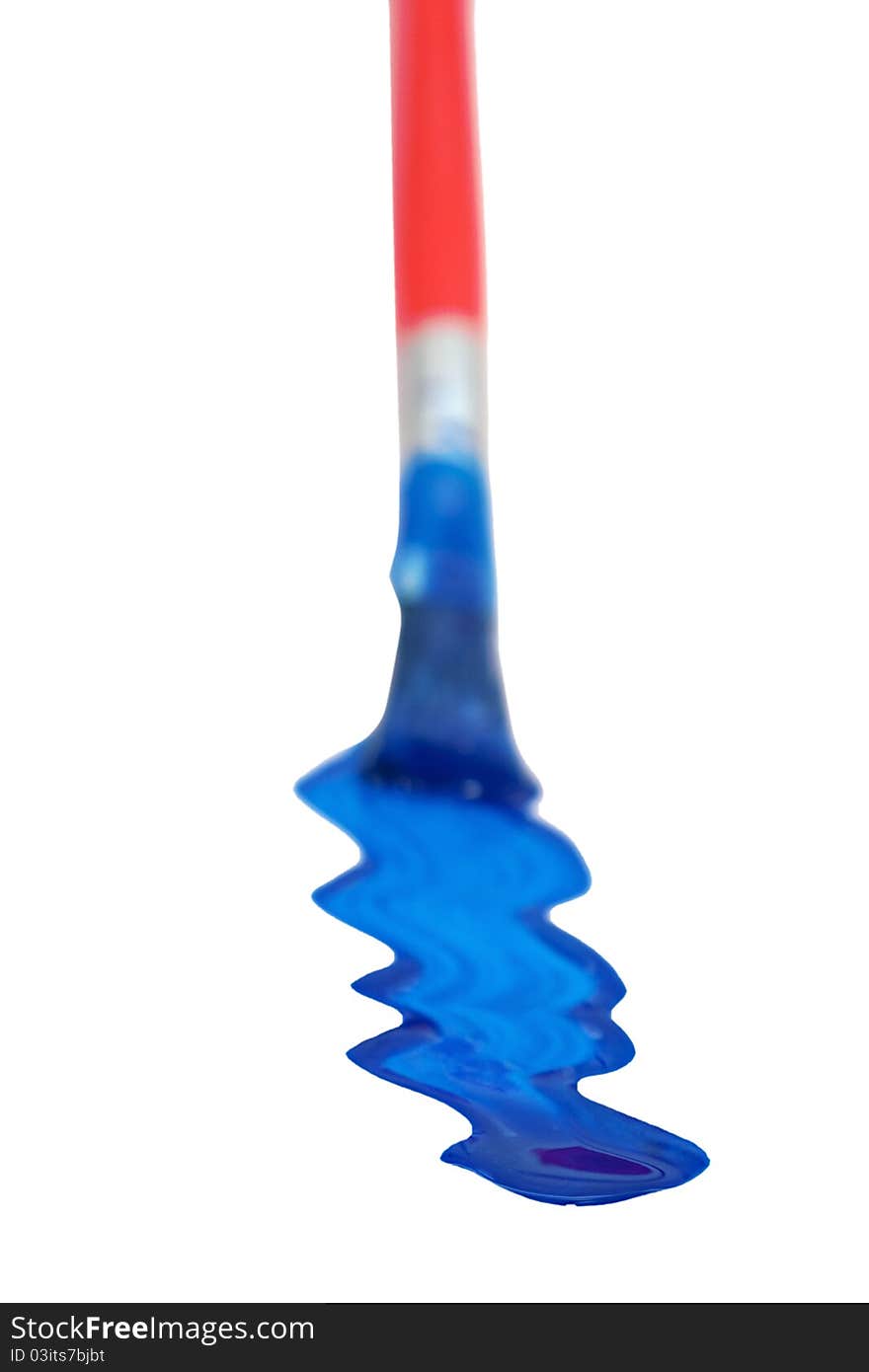 Paintbrush with blue paint stripe shallow depth of field