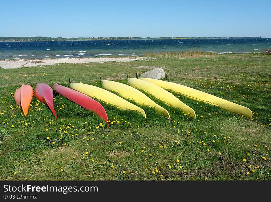 Kayaks on the beach ready for action - sea sport background image. Kayaks on the beach ready for action - sea sport background image