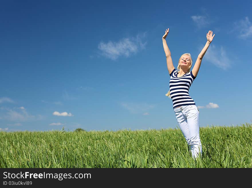 Young blond woman in blue dress in the park. Young blond woman in blue dress in the park