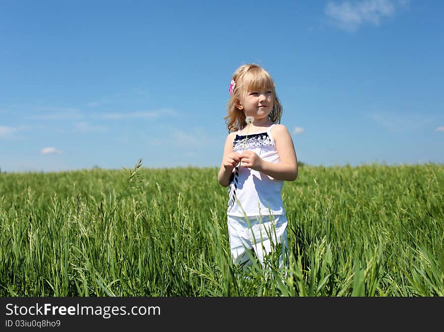 Little girl outdoors in sunny summer day