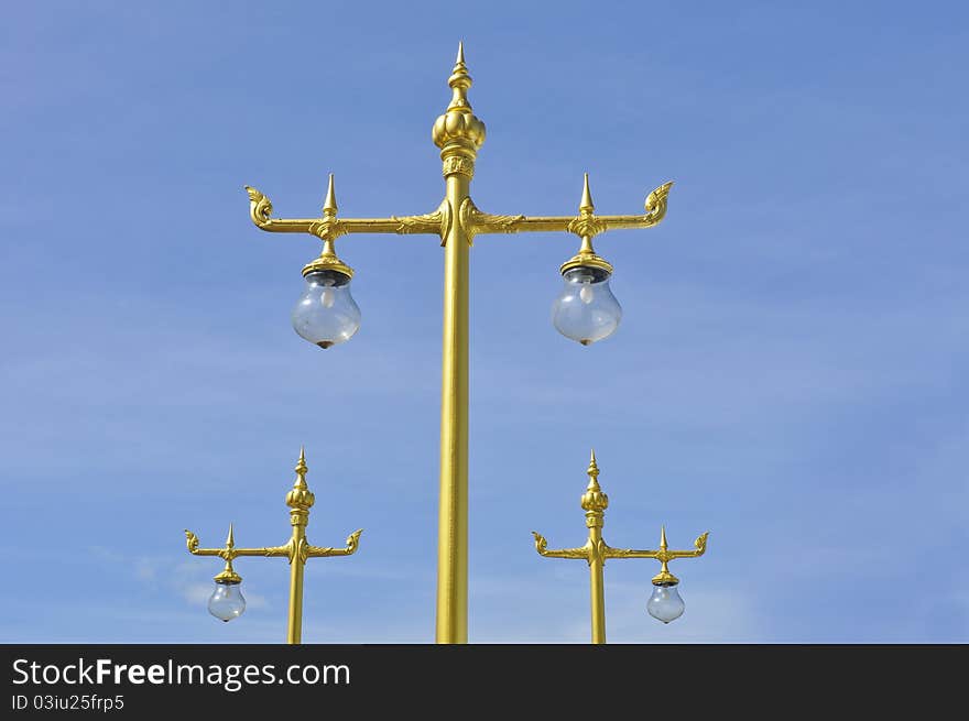 Golden Thai street lamp with blue sky