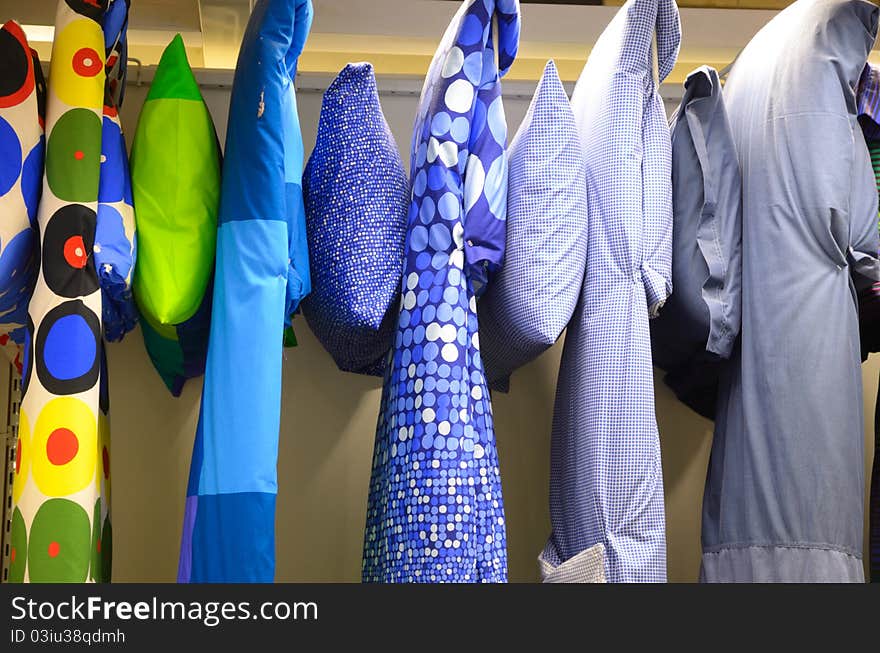 Those colorful quilts and pillows are put in shopping windows to be sold. Those colorful quilts and pillows are put in shopping windows to be sold.