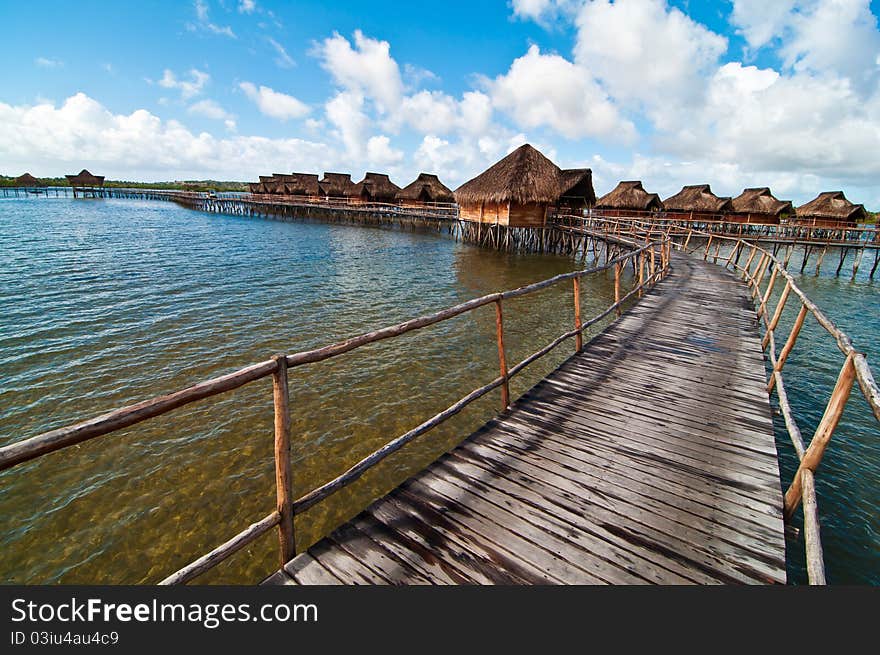 A resort of bungalows suspended on the water in the lagoon at Inhamabane, Mozambique. A resort of bungalows suspended on the water in the lagoon at Inhamabane, Mozambique