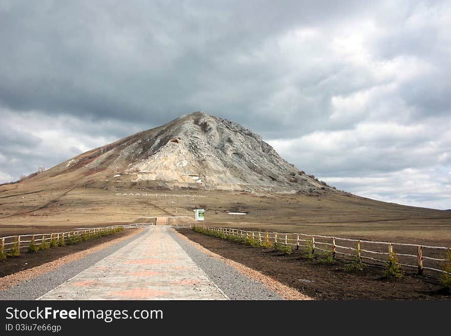 High mountain on a background of the grey sky