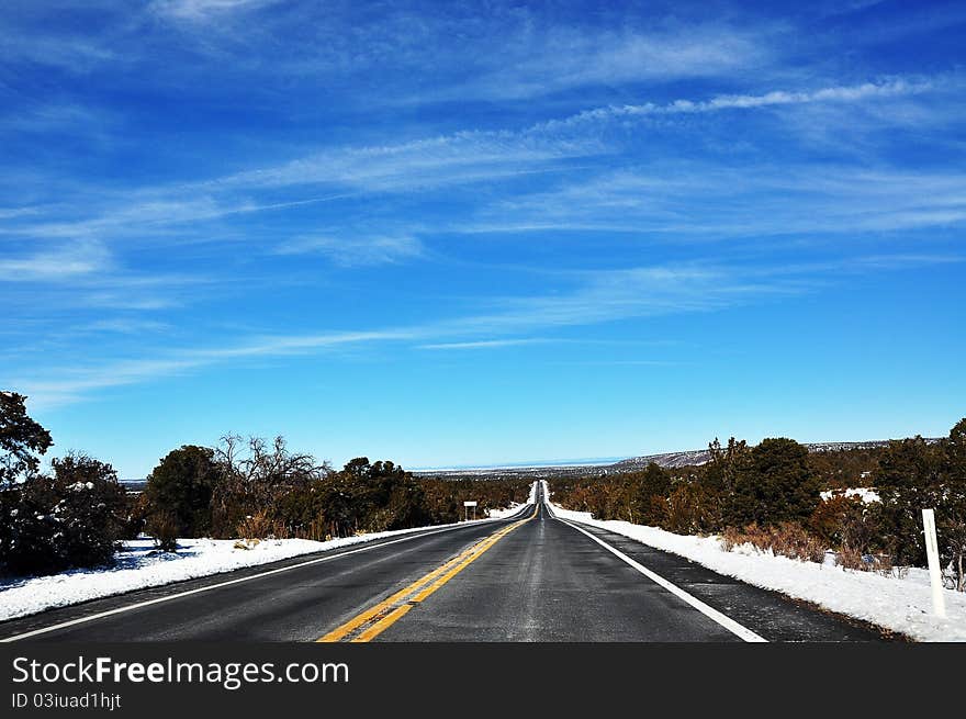 An unknown US highway surrounded by snow-covered atmosphere. An unknown US highway surrounded by snow-covered atmosphere