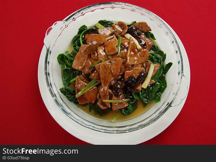 The spinach fry pig liver is very popular a China home cooking. The spinach fry pig liver is very popular a China home cooking