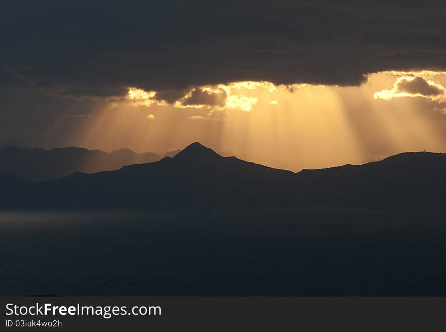 Sunset above an outline of a mountain