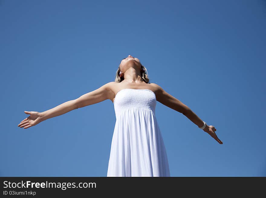 Woman having stretched hands aspires in the sky