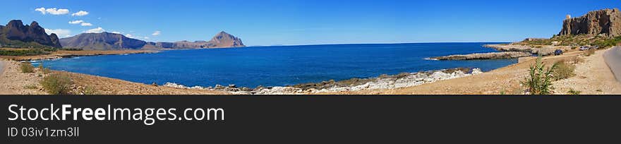 Beautiful natural landscape, view from the Monte Cofano mountain across the Macari Bay and the watchtower Location: Macari Bay and Monte Cofano Mountain in Sicily, Italy, Europe Horizontal panoramic image, 8 horizontal images stitched together into a panoramic image. Beautiful natural landscape, view from the Monte Cofano mountain across the Macari Bay and the watchtower Location: Macari Bay and Monte Cofano Mountain in Sicily, Italy, Europe Horizontal panoramic image, 8 horizontal images stitched together into a panoramic image