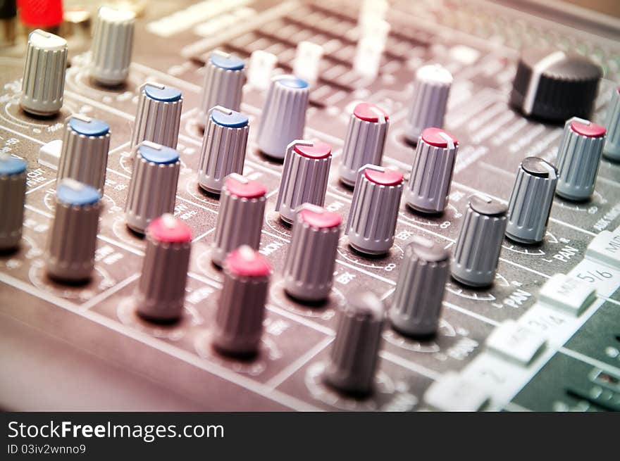 Close up shot of sound mixer in studio