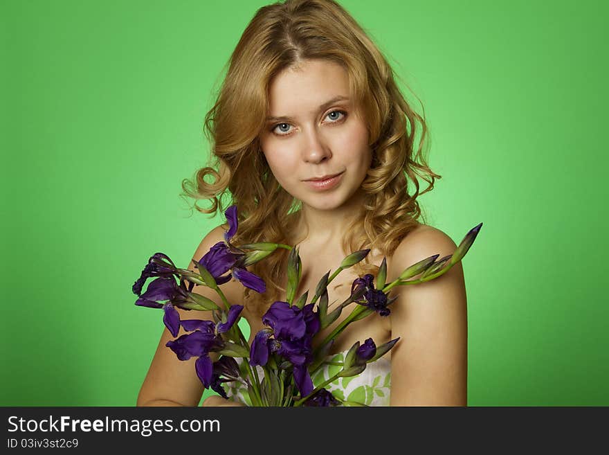 HappyClose up on a green background Happy young woman hugging a yellow tulip. Young Woman Hugging Flower. HappyClose up on a green background Happy young woman hugging a yellow tulip. Young Woman Hugging Flower