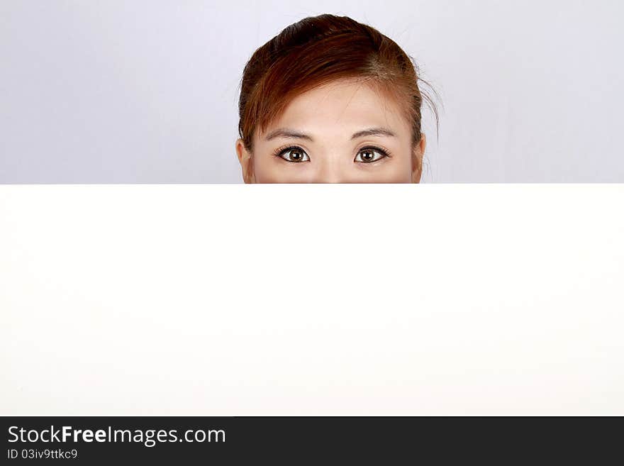 Young business woman with a white sign board. Young business woman with a white sign board.