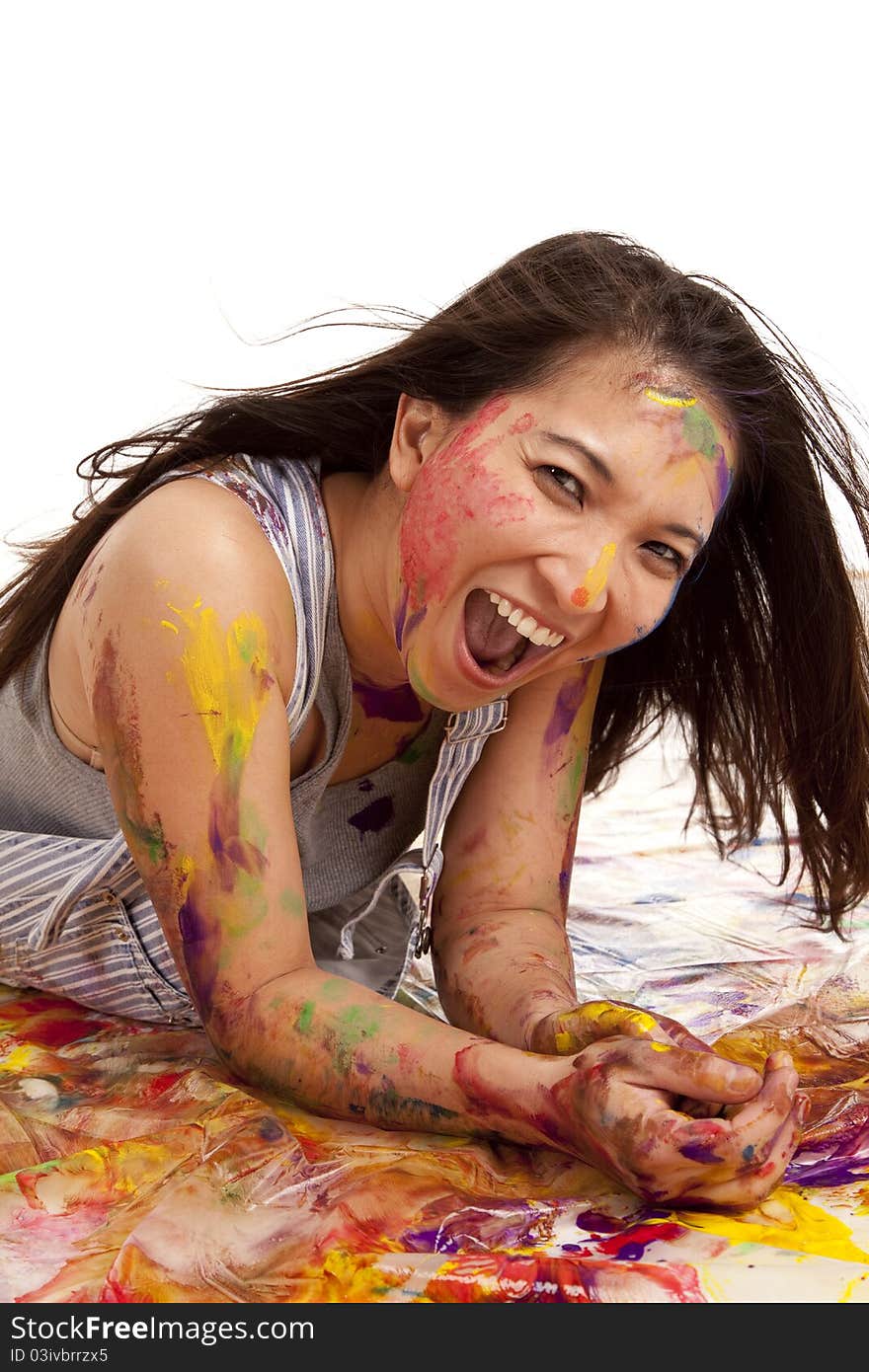 A woman having fun laying in paint, she has a big smile on her face. A woman having fun laying in paint, she has a big smile on her face.