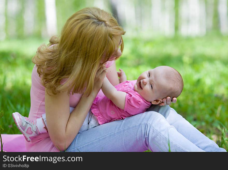 Mother and daughter in birch spring or summer park. Mother and daughter in birch spring or summer park