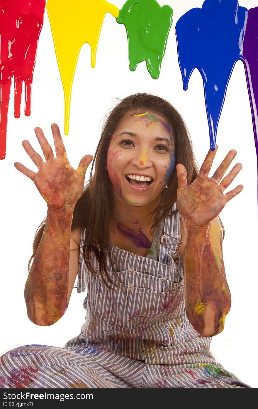 A woman with her hands up while paint dripps down. A woman with her hands up while paint dripps down.