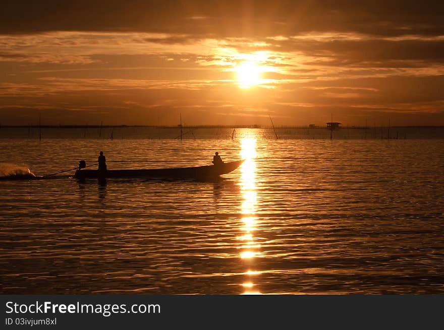 Fishermen boat in sunset