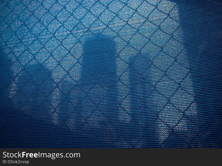 Blue curtain as a screen of a large construction site. Blue curtain as a screen of a large construction site