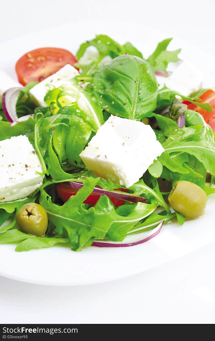 Healthy vegetarian salad on a plate on a white background. Healthy vegetarian salad on a plate on a white background