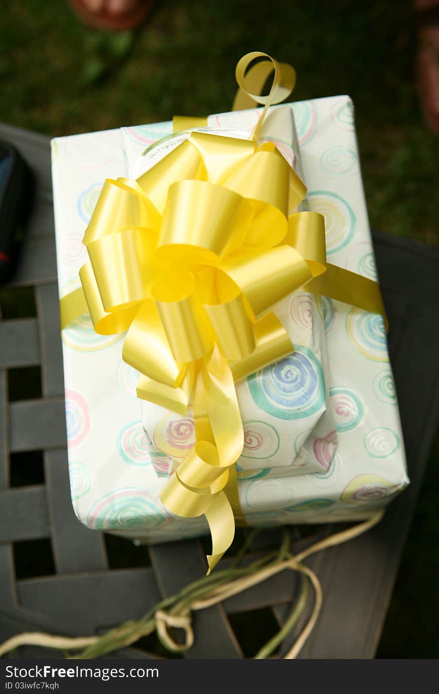 This is a picture of two wrapped gifts, tied with a yellow ribbon and bow. This is a picture of two wrapped gifts, tied with a yellow ribbon and bow.