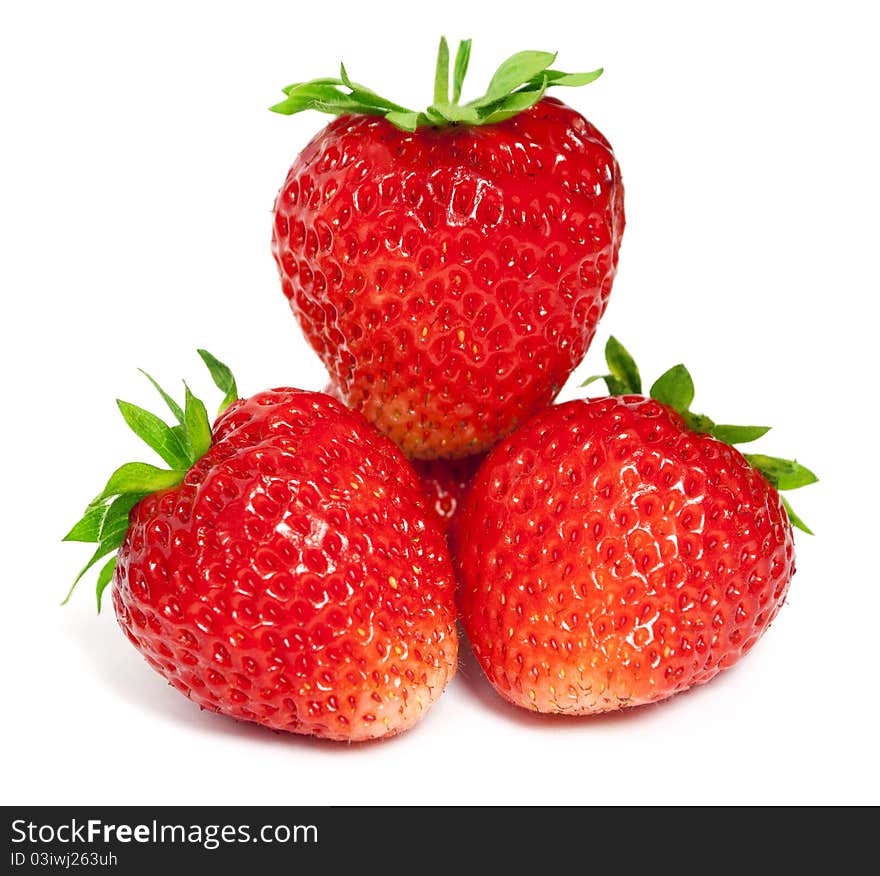 Three ripe strawberries on a white background