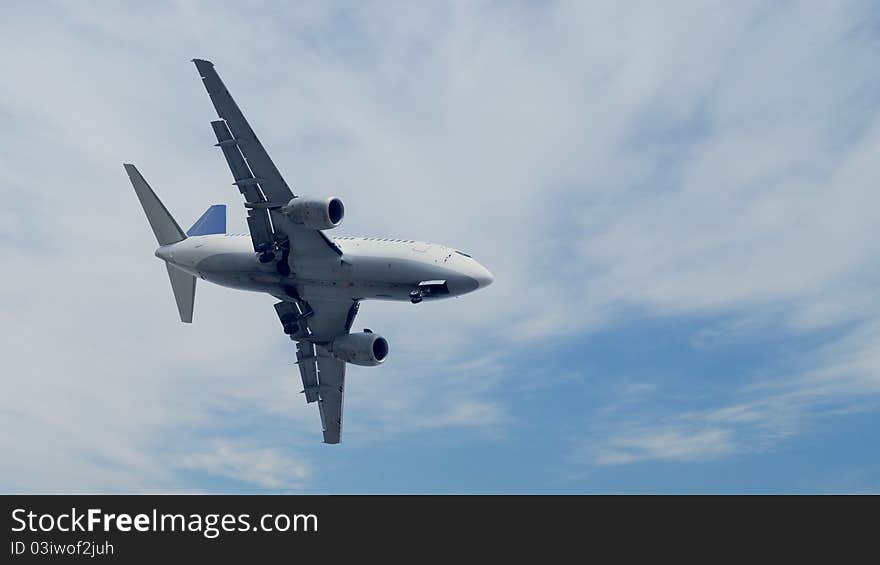 Passanger airplane fly under clouds.