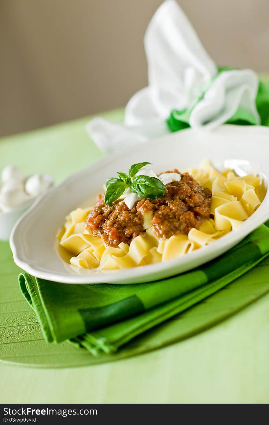 Delicious pasta with tomato meat sauce and mozzarella chips over it