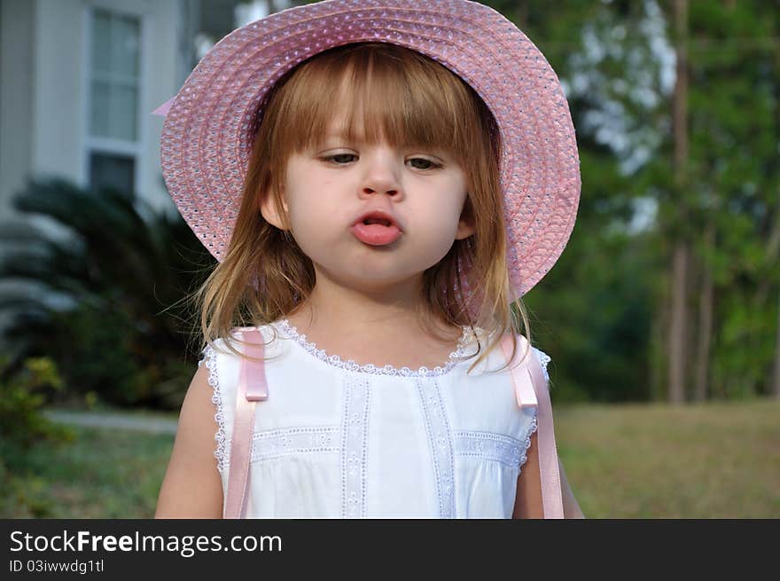 Toddler girl preparing to give a kiss. Toddler girl preparing to give a kiss.