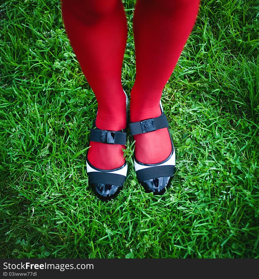 Woman's feet in shoes, against green grass. Woman's feet in shoes, against green grass