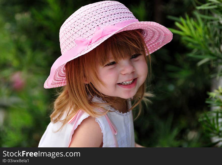 Toddler girl smiling while playing outside. Toddler girl smiling while playing outside.