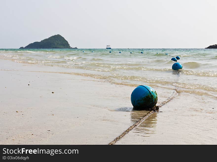 Blue buoy on the beach