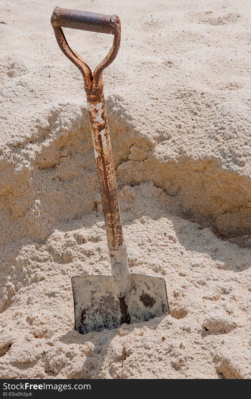 A picture of a shovel in sand