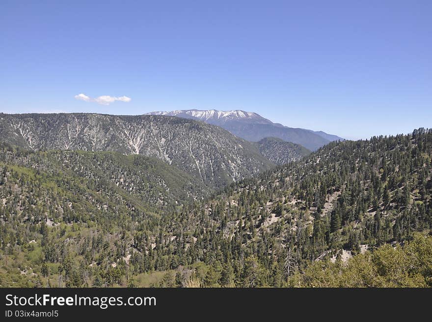 A beautiful landscape of snow capped mountains in the forest of Big Bear Lake in southern California. A beautiful landscape of snow capped mountains in the forest of Big Bear Lake in southern California