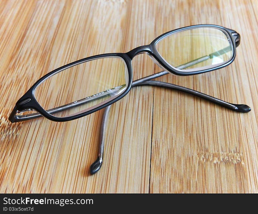 Diopter glasses on a wooden table.