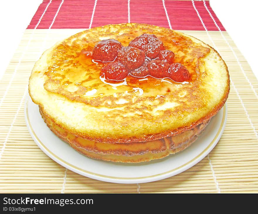 Three pancakes with strawberry jam isolated