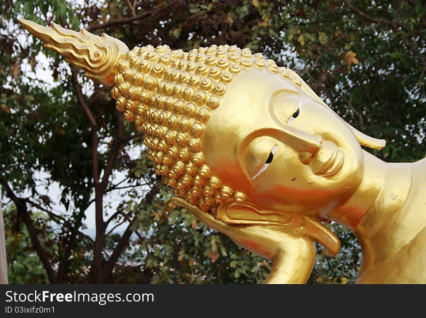 Closeup of reclining Buddha face at a Wat in Pattaya, Thailand. Closeup of reclining Buddha face at a Wat in Pattaya, Thailand