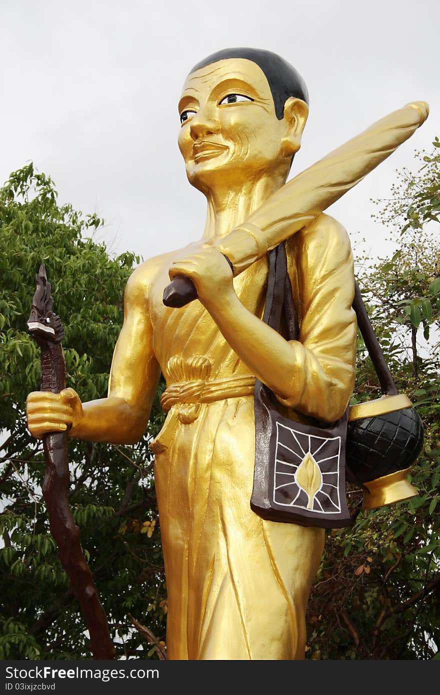 Walking Buddha with stick at a Wat in Pattaya, Thailand