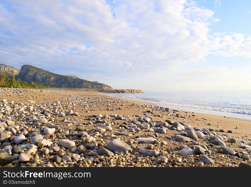 On the shore of a calm sea in clear weather. On the shore of a calm sea in clear weather