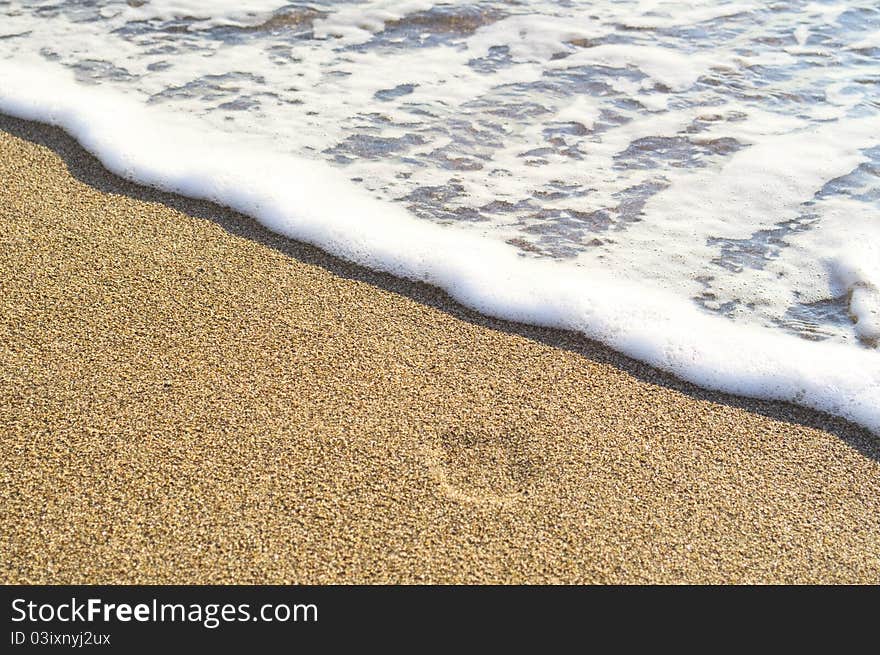 Golden sand beach lapped by the waves of the sea. Golden sand beach lapped by the waves of the sea